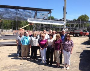 Hingham Municipal Lighting Plant employees recently joined CTA Construction for the topping-off ceremony at the site of its future headquarters on Bare Cove Park Road. The final steel beam, painted white, was autographed by the employees and hoisted into place to complete the building frame.