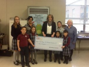 Jonelle Lawhorn, KBE Director of Marketing, formally presents the donation to St. Mary-St. Michael School students in Derby, CT/Ralph Nicafaro